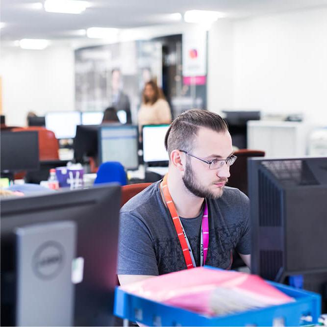 Mitie security employees working at computers in an office environment